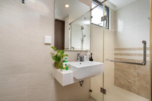 a bathroom with a white sink and a shower at Studio-River view-Hana Apart-2 in Ho Chi Minh City