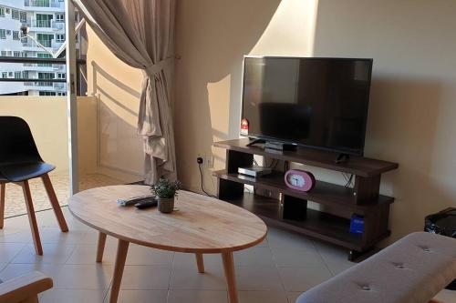 a living room with a tv and a coffee table at 1. Luxury Kristal condo 1 丹绒亚路市中心高級住宅 in Kota Kinabalu
