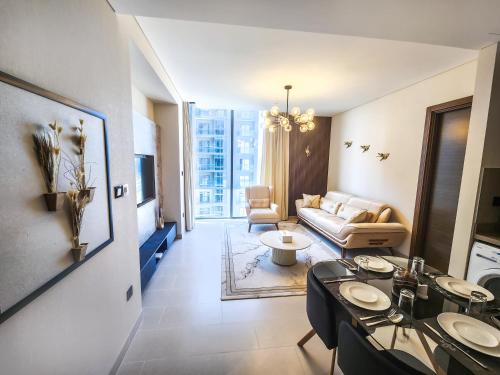 a living room with a couch and a table at STAY BY LATINEM Luxury 2BR Holiday Home CV B2302 near Burj Khalifa in Dubai