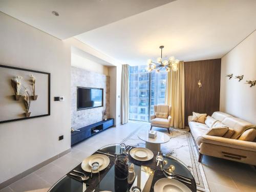 a living room with a couch and a table at STAY BY LATINEM Luxury 2BR Holiday Home CV B2302 near Burj Khalifa in Dubai