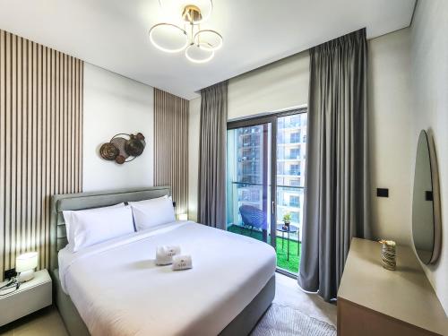 a bedroom with a large bed and a large window at STAY BY LATINEM Luxury 2BR Holiday Home CV B2302 near Burj Khalifa in Dubai