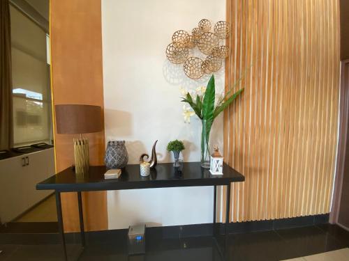 Czarny stół z rośliną w pokoju w obiekcie Compact Studio Unit @ Centrio Tower w mieście Cagayan de Oro