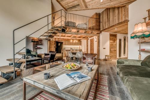 a living room with a couch and a table at Hotel & Spa Le Val d'Isère in Val dʼIsère