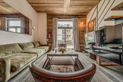 a living room with a couch and a table at Hotel & Spa Le Val d'Isère in Val dʼIsère