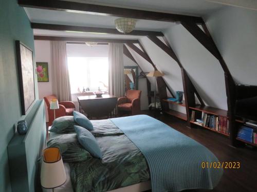 a bedroom with a large bed and a window at Het Burgemeestershuis in Barsingerhorn