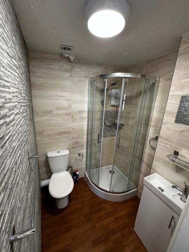 a bathroom with a shower and a toilet and a sink at VM Holiday let in Great Yarmouth