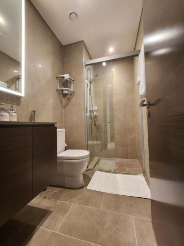 a bathroom with a toilet and a glass shower at STAY BY LATINEM Luxury 2BR Holiday Home CV B2302 near Burj Khalifa in Dubai