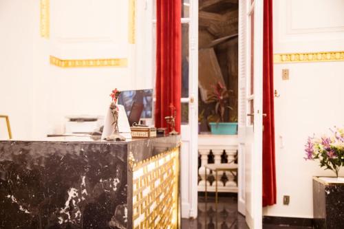 a room with a counter and a red curtain at Palace Court in Cairo