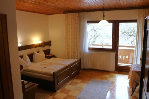 ein Schlafzimmer mit einem Bett und einem großen Fenster in der Unterkunft Hof zur Steinwänd in Micheldorf in Oberösterreich