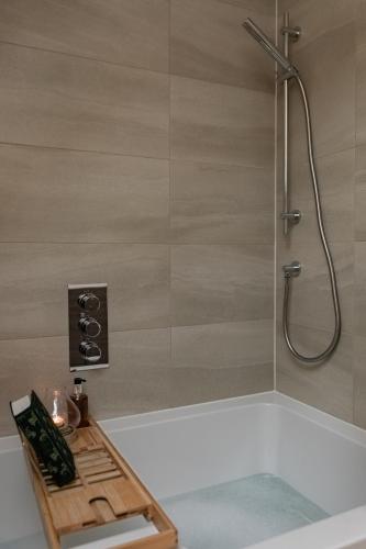 a bathroom with a shower with a bath tub at Luxury Eton Cottage-Design Led in Eton
