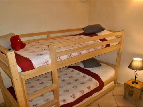 a bedroom with two bunk beds with a teddy bear on top at Appartement Samoëns, 2 pièces, 5 personnes - FR-1-624-41 in Samoëns