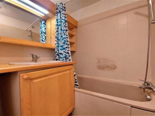 a bathroom with a sink and a tub and a shower at Appartement Samoëns, 2 pièces, 4 personnes - FR-1-624-61 in Samoëns