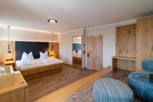 a hotel room with two beds and a desk at Hotel & Gasthof Richard Held in Regensburg