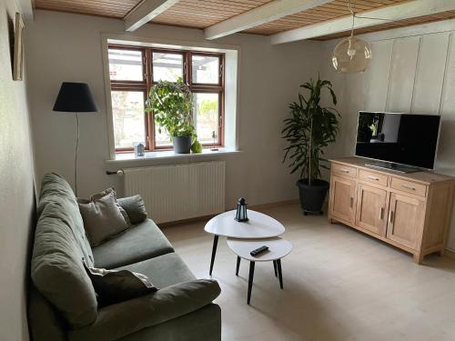 uma sala de estar com um sofá e uma mesa em Feriestedet Rønne em Billum