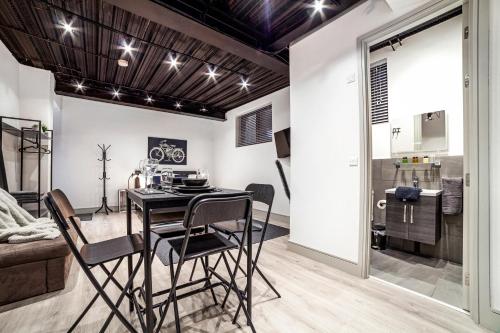 a kitchen and dining room with a table and chairs at Modern Luxury Studios London in London