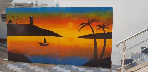a painting of a sunset on a wall at Athi Resorts in Bogmolo
