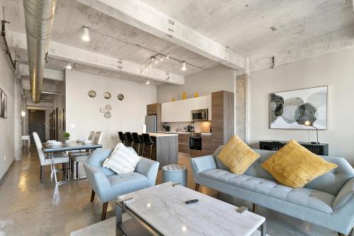 a living room with two blue couches and a table at Luxury Downtown Dallas Stay by Amyfinehouse in Dallas