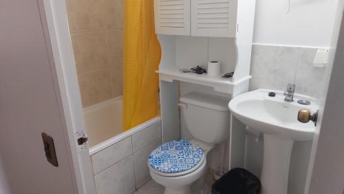 a small bathroom with a toilet and a sink at Iquique todo el año in Iquique
