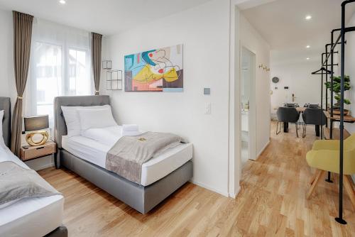 a bedroom with a bed and a dining room at St Georgen-Strasse Studios by VISIMO - Design, City, Nature in St. Gallen