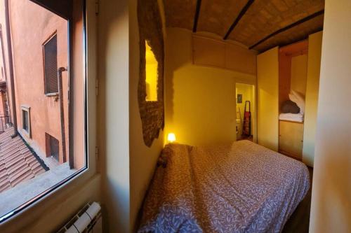 a bedroom with a bed in a room with a window at Julia nel cuore di Trastevere in Rome