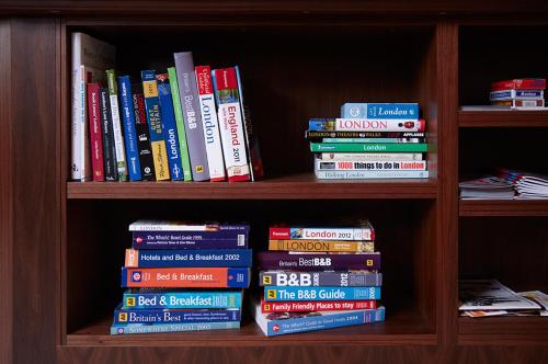 a book shelf filled with lots of books at The Windermere Hotel, London in London