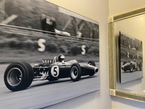 a black and white picture of a racing car on a wall at The Windermere Hotel, London in London