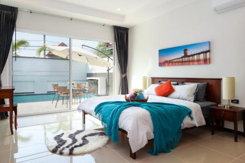 sypialnia z dużym łóżkiem i balkonem w obiekcie *City~house* 芭堤雅豪华泳池别墅近步行街 w Pattaya South