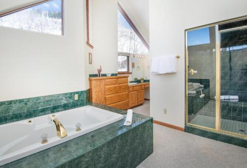 a large bathroom with a tub and a shower at 4551 Streamside Cir WEST HOUSE in Vail