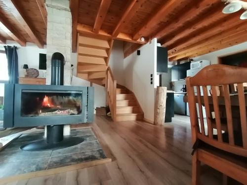 a fireplace in the living room of a house at Lodge bien être et nature in Soultzeren