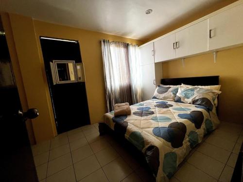 a bedroom with a bed in a room with yellow walls at Lovely 3-Bed House in Talisay Cebu Philippines in Talisay
