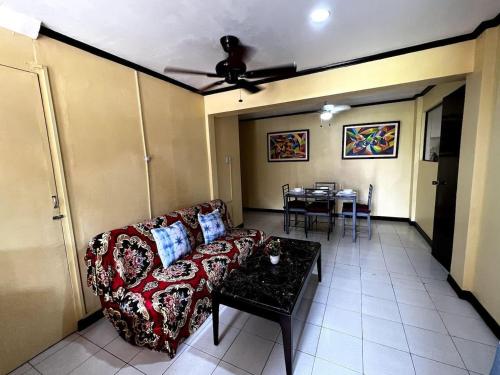 a living room with a couch and a table at Lovely 3-Bed House in Talisay Cebu Philippines in Talisay