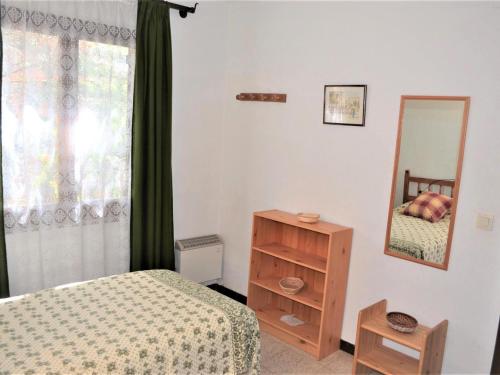 a bedroom with a bed and a dresser and a mirror at Casa Dynaida in Begur