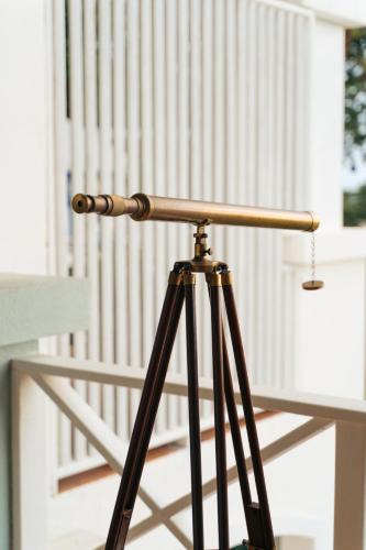 a telescope on top of a tripod next to a table at Blue Roatan Resort in West Bay