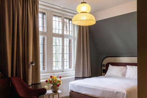 a bedroom with a bed and a large window at Boutique Hotel Waldhaus beider Basel in Basel