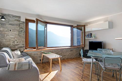 a living room with a couch and a table at Renovated Barn of the year 1500 in Moltrasio