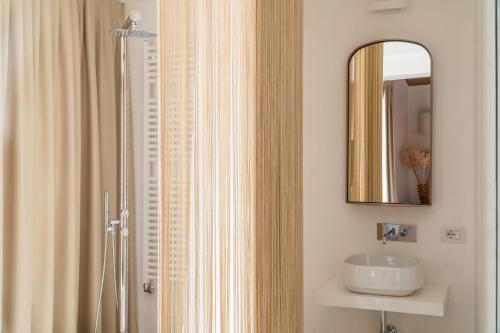 a bathroom with a sink and a mirror at Ninfea Luxury Suites in Venice