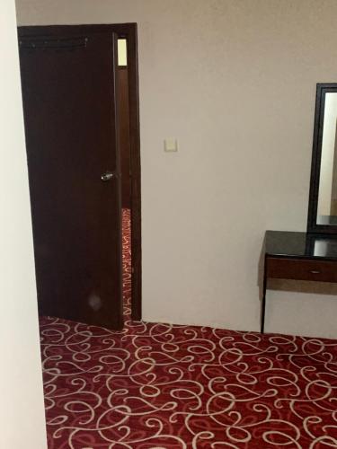 a bedroom with a bed and a door and a dresser at Ankara apart hostel 3 in Altındağ