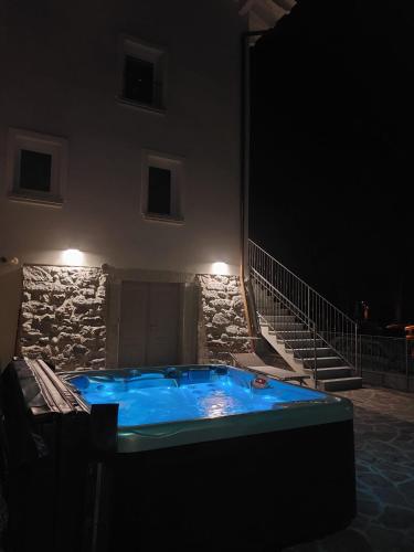 a large blue hot tub in a building at night at Casa Angelina in Crone