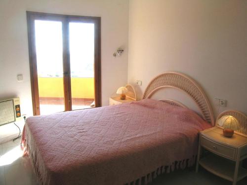 a bedroom with a large bed and a window at La gervaise in Begur