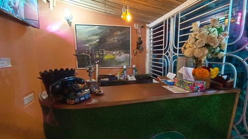 a reception desk in a room with a mirror at Banorupa Kuakata hotel in Kuākāta