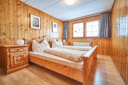 - une chambre avec un lit dans un mur en bois dans l'établissement Hof Stein Schwellbrunn, à Schwellbrunn