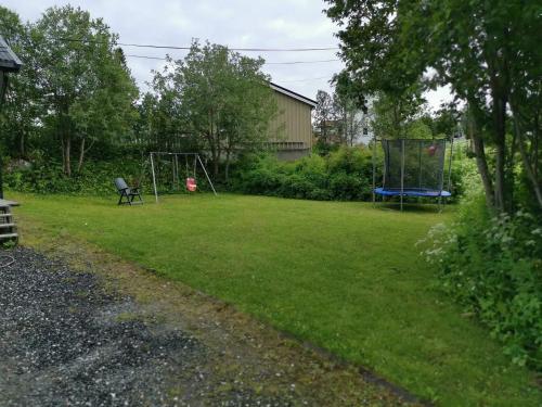 a yard with a swing set and a playground at Big, spacious apartment with free parking in Tromsø