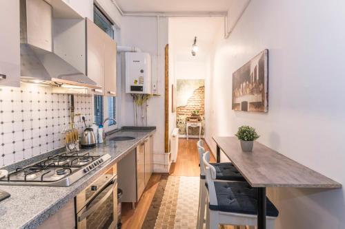 a kitchen with white appliances and a counter top at By Galata- Historical and Modern Apartment in Istanbul