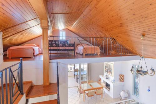 a room with a bed and a staircase in a house at Lefkathia Beach Villa - Gated Beach-Front Private Villa at Lefkathia Beach, Chios! in Volissos