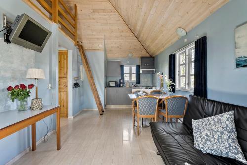 a living room with a couch and a table at First Camp Bøsøre Strand Feriepark in Hesselager