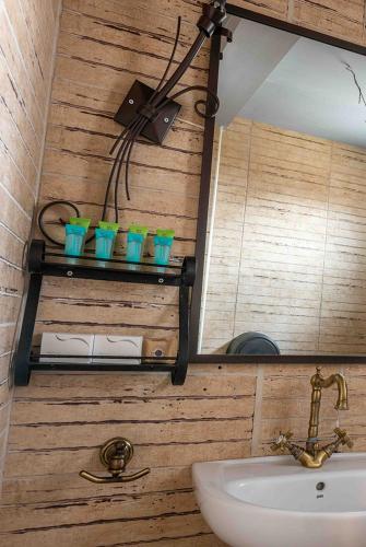 a bathroom with a sink and a mirror at Lithea Mountain Resort in Florina