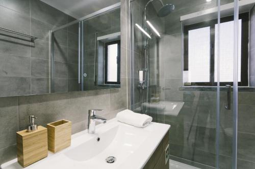a bathroom with a sink and a glass shower at Best Houses 73 - Lovely view São Bernardino in Atouguia da Baleia