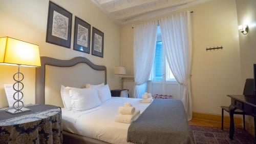 a bedroom with a bed with a teddy bear on it at MGPGroup Guest House Piazza Navona in Rome