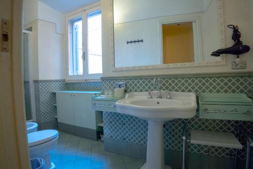 a bathroom with a sink and a toilet and a mirror at MGPGroup Guest House Piazza Navona in Rome