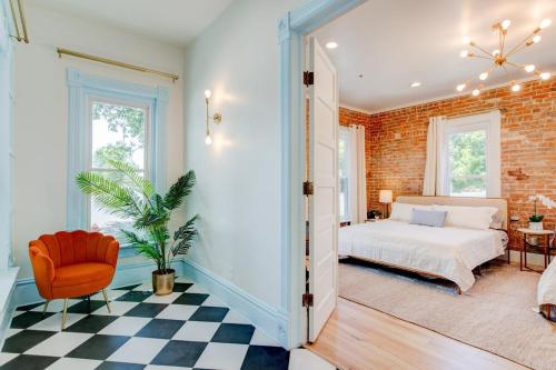 a bedroom with a bed and a brick wall at Suite 1 Historic Art City Inn in Springville